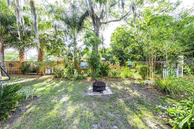 562 NE 2nd Ave, Gainesville, FL 32601 - fenced backyard featuring an outdoor fire pit