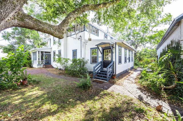 562 NE 2nd Ave, Gainesville, FL 32601 - rear view of house with a sunroom