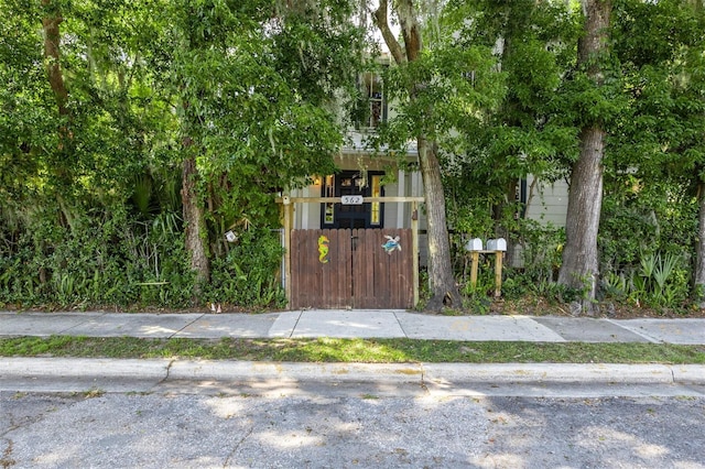 562 NE 2nd Ave, Gainesville, FL 32601 - obstructed view of property with a fenced front yard and a gate