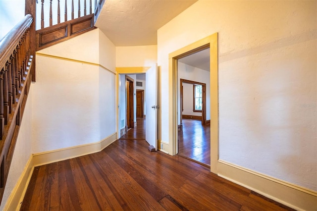 562 NE 2nd Ave, Gainesville, FL 32601 - spare room with dark wood-type flooring and baseboards