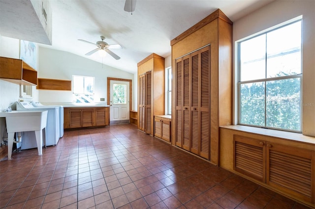 562 NE 2nd Ave, Gainesville, FL 32601 - kitchen featuring ceiling fan, washer / clothes dryer, vaulted ceiling, dark tile patterned flooring, and light countertops