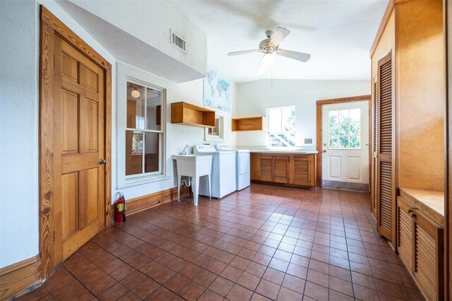 562 NE 2nd Ave, Gainesville, FL 32601 - laundry area with cabinet space, independent washer and dryer, ceiling fan, and dark tile patterned floors