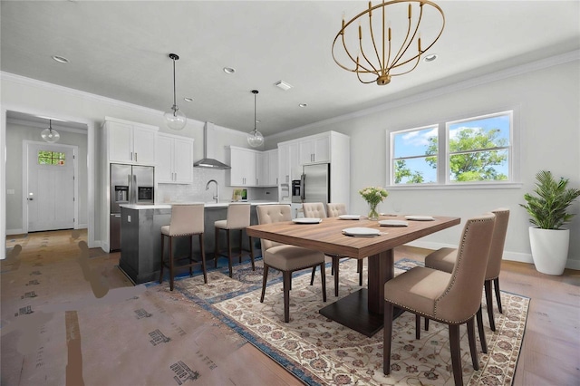 dining room with crown molding and baseboards