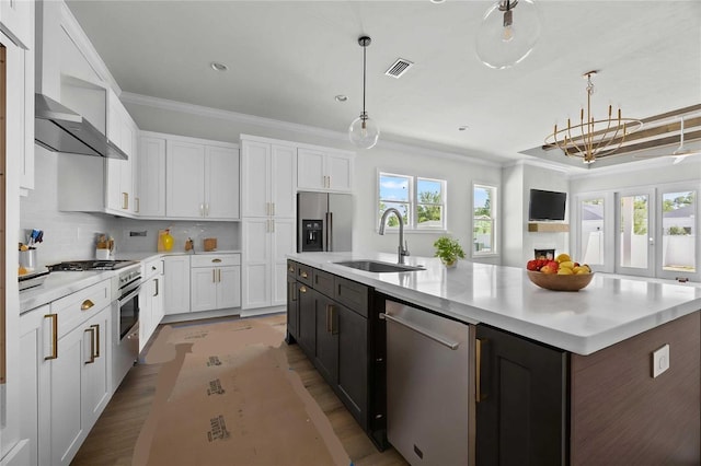 kitchen featuring a sink, visible vents, appliances with stainless steel finishes, and crown molding