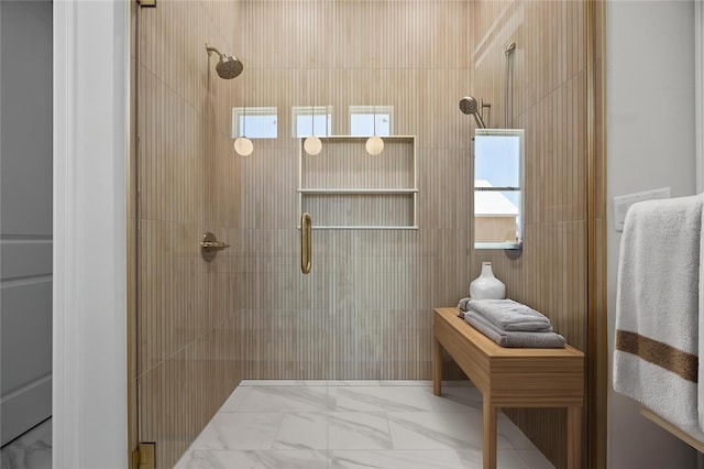 full bathroom with a tile shower and marble finish floor