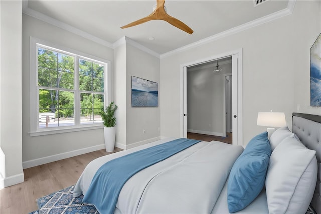 bedroom with wood finished floors, ceiling fan, baseboards, and ornamental molding