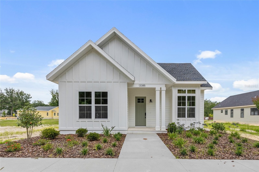 13385 SW 9th Rd, Newberry, FL 32669 - modern farmhouse style home featuring board and batten siding, covered porch, and a shingled roof