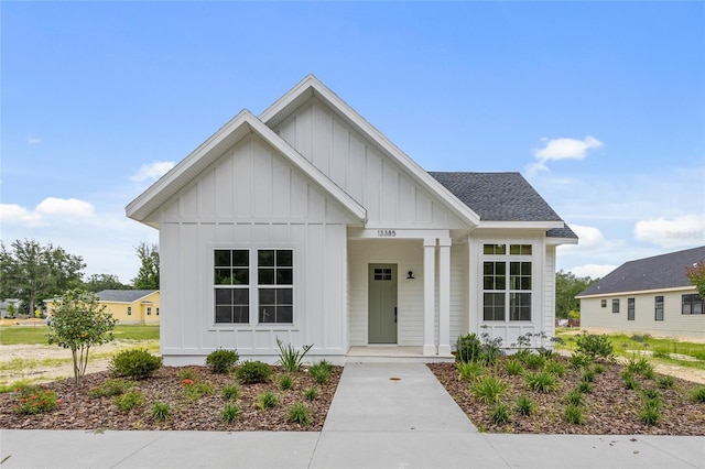 13385 SW 9th Rd, Newberry, FL 32669 - modern farmhouse style home featuring board and batten siding, covered porch, and a shingled roof