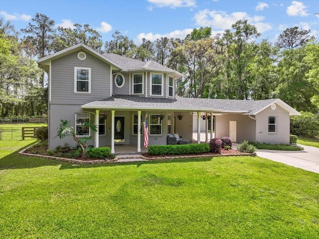 14127 NW 23rd Ln, Gainesville, FL 32606 - view of front facade with covered porch, stucco siding, concrete driveway, roof with shingles, and view of wooded area