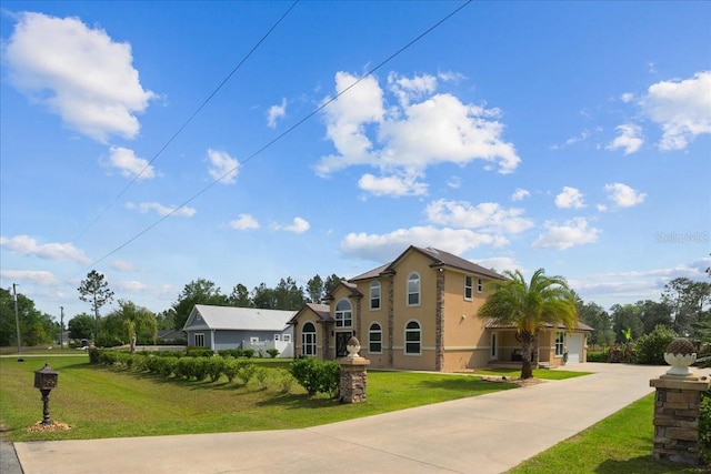 9835 SW 80th Pl, Hampton, FL 32044 - view of front of home featuring a front lawn, a garage, driveway, and stucco siding