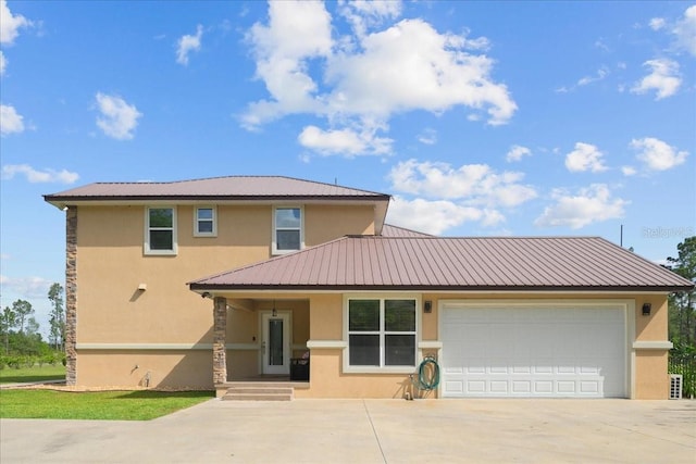 9835 SW 80th Pl, Hampton, FL 32044 - view of front of property featuring driveway, stucco siding, metal roof, and a garage