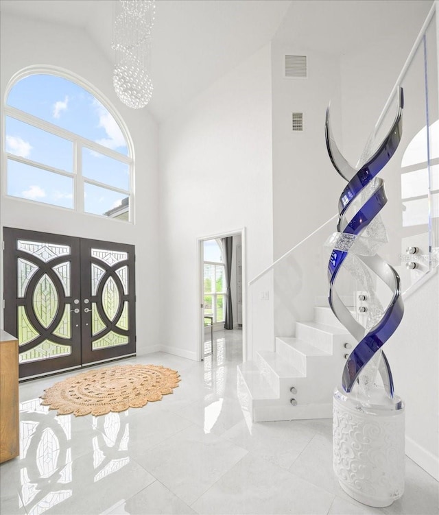 9835 SW 80th Pl, Hampton, FL 32044 - foyer featuring french doors, high vaulted ceiling, baseboards, and visible vents