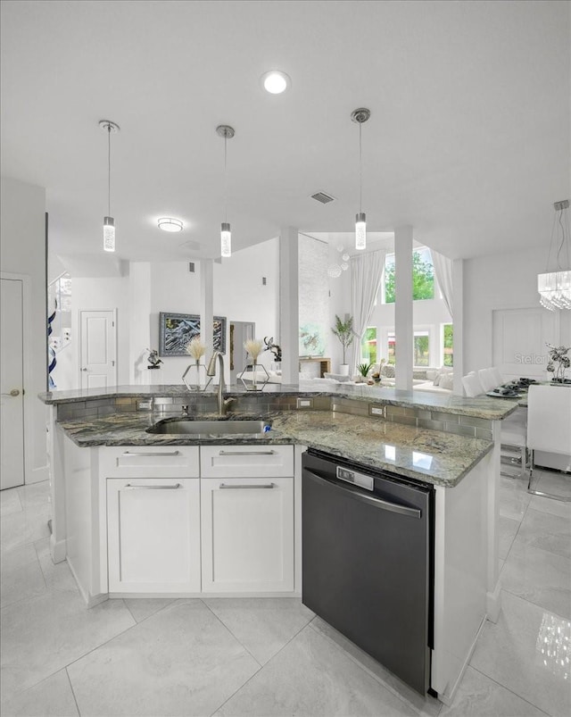 9835 SW 80th Pl, Hampton, FL 32044 - kitchen with visible vents, a sink, open floor plan, dishwashing machine, and light stone counters