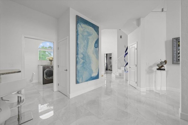 9835 SW 80th Pl, Hampton, FL 32044 - corridor with washer / clothes dryer, a towering ceiling, and marble finish floor