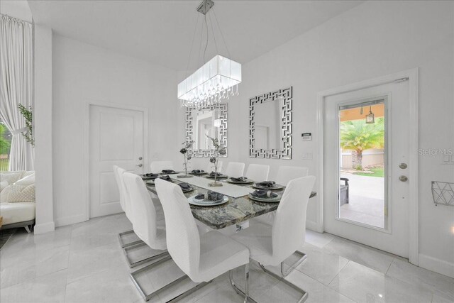 9835 SW 80th Pl, Hampton, FL 32044 - dining room with light tile patterned floors, a notable chandelier, and baseboards
