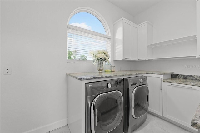 9835 SW 80th Pl, Hampton, FL 32044 - laundry area featuring washer and dryer, light tile patterned floors, cabinet space, and a wealth of natural light