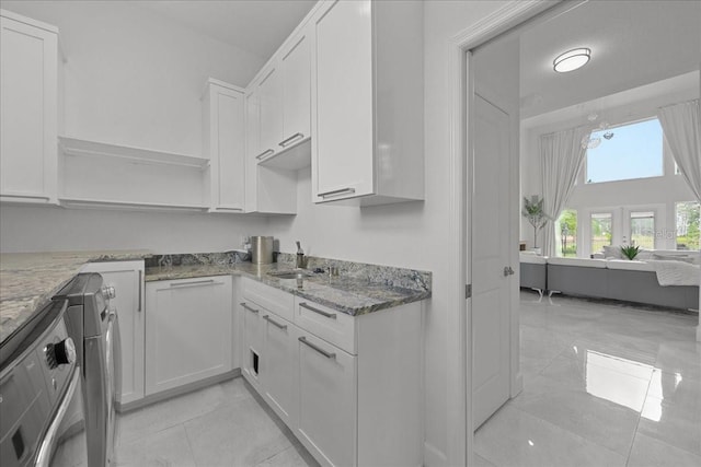 9835 SW 80th Pl, Hampton, FL 32044 - kitchen featuring open shelves, white cabinetry, a sink, and light stone counters