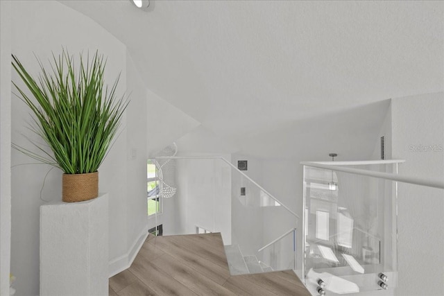 9835 SW 80th Pl, Hampton, FL 32044 - stairway featuring wood finished floors, visible vents, and lofted ceiling