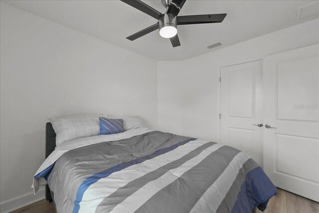 9835 SW 80th Pl, Hampton, FL 32044 - bedroom with visible vents, baseboards, a ceiling fan, and wood finished floors