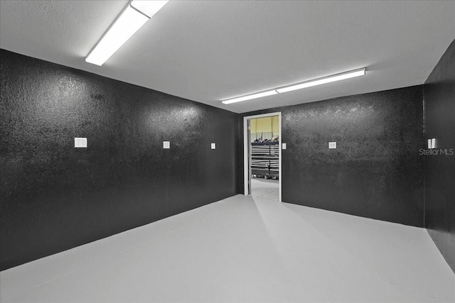 9835 SW 80th Pl, Hampton, FL 32044 - unfurnished room with concrete floors and a textured wall