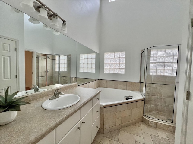 11795 Creek Dr, Alachua, FL 32615 - bathroom featuring vanity, a stall shower, a towering ceiling, and a garden tub