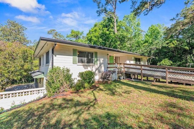 3904 NW 15th St, Gainesville, FL 32605 - ranch-style house featuring a front yard and a wooden deck