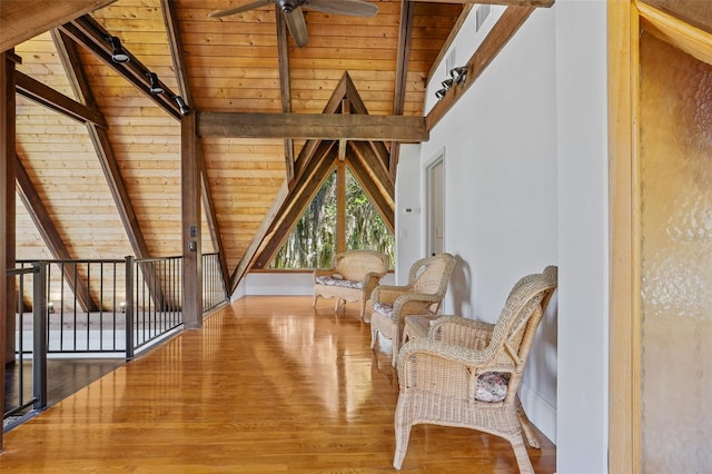 sitting room featuring wooden ceiling, wood finished floors, and lofted ceiling with beams