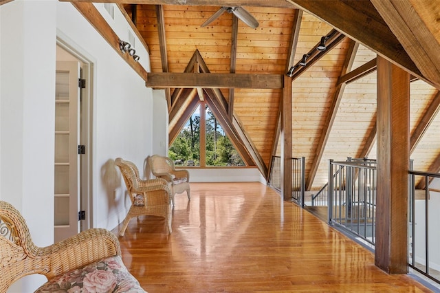 sitting room with wood ceiling, wood finished floors, and lofted ceiling with beams