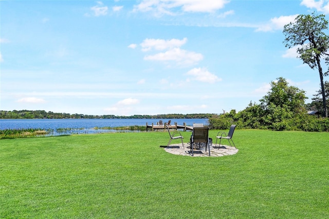view of yard with a water view and a patio