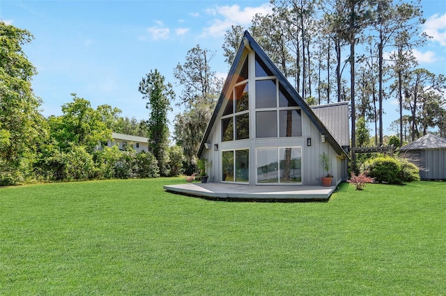 back of property featuring a lawn