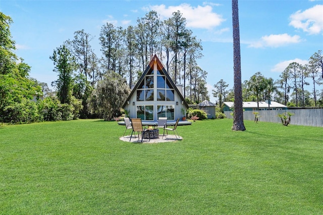 view of yard with fence and a patio
