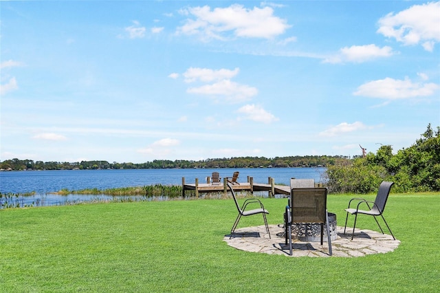 view of yard with a boat dock and a water view
