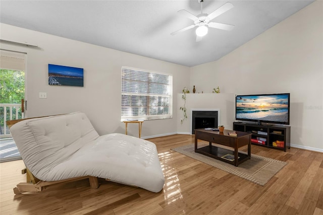 10000 SW 52nd Ave Unit 77, Gainesville, FL 32608 - living room with light wood-style flooring, ceiling fan, vaulted ceiling, and baseboards