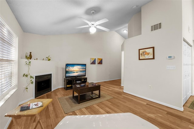 10000 SW 52nd Ave Unit 77, Gainesville, FL 32608 - living area featuring visible vents, ceiling fan, wood finished floors, and a fireplace