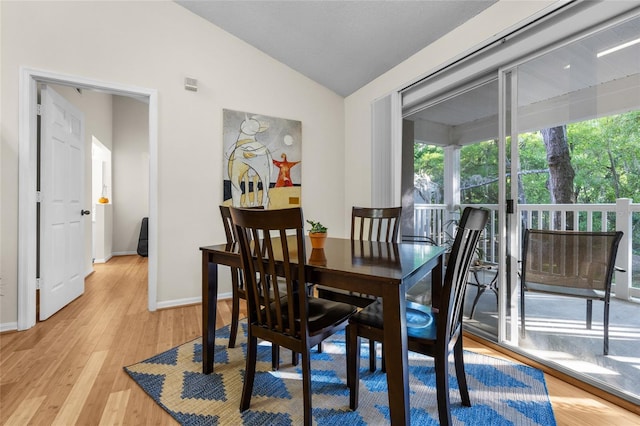10000 SW 52nd Ave Unit 77, Gainesville, FL 32608 - dining area with light wood-style flooring, baseboards, and vaulted ceiling