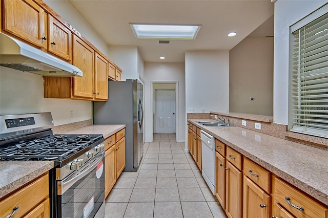 1983 SW 65th Dr, Gainesville, FL 32607 - kitchen featuring stainless steel gas stove, under cabinet range hood, dishwasher, light tile patterned flooring, and light countertops