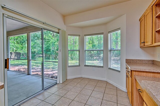 1983 SW 65th Dr, Gainesville, FL 32607 - unfurnished dining area featuring healthy amount of natural light and light tile patterned floors