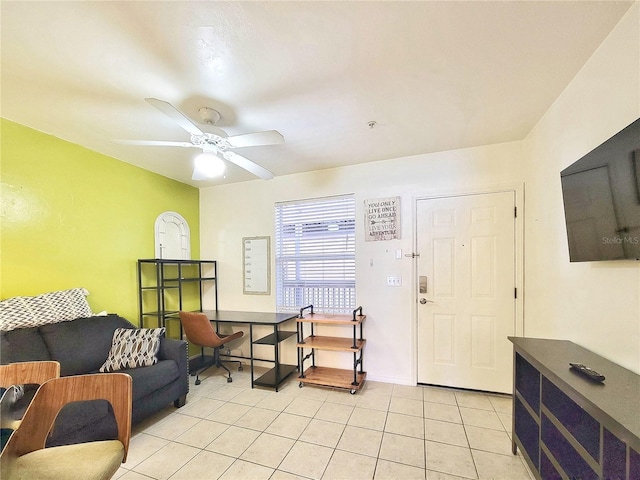 interior space with a ceiling fan and light tile patterned floors