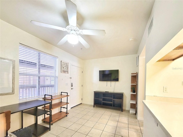 interior space featuring ceiling fan, baseboards, visible vents, and light tile patterned floors