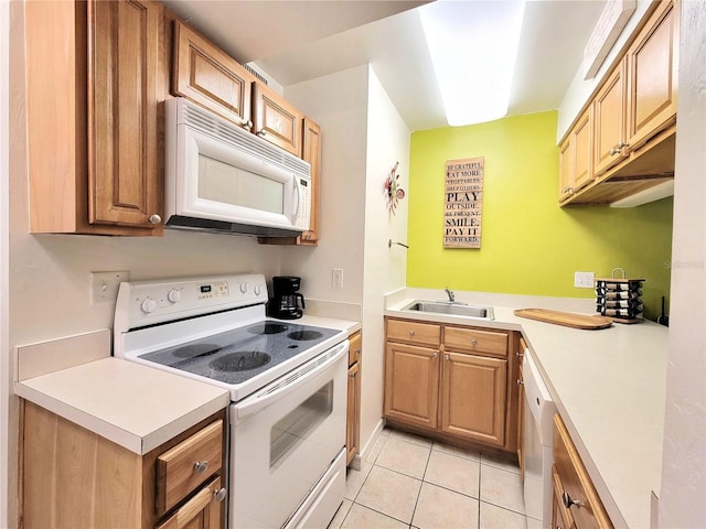 kitchen featuring light countertops, light tile patterned floors, a sink, and white appliances