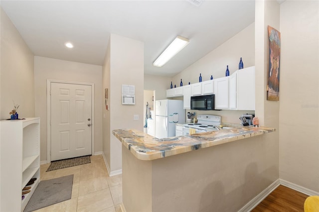 3118 NW 79th Ct, Gainesville, FL 32606 - kitchen with white appliances, white cabinetry, light countertops, and baseboards