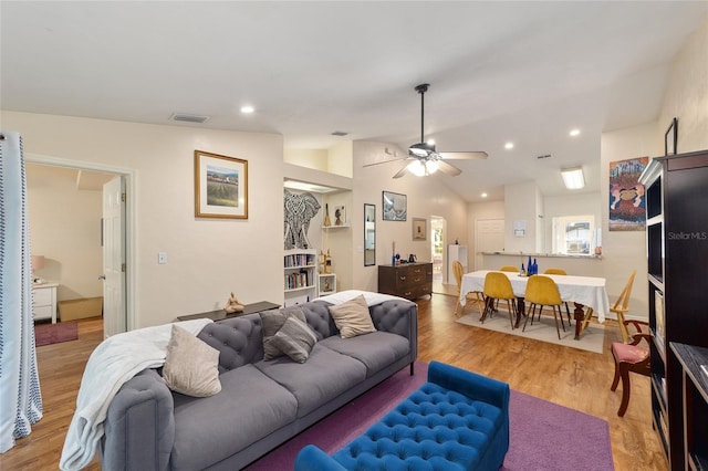 3118 NW 79th Ct, Gainesville, FL 32606 - living room with a ceiling fan, light wood-style flooring, and vaulted ceiling
