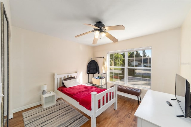3118 NW 79th Ct, Gainesville, FL 32606 - bedroom with wood finished floors, a ceiling fan, and baseboards