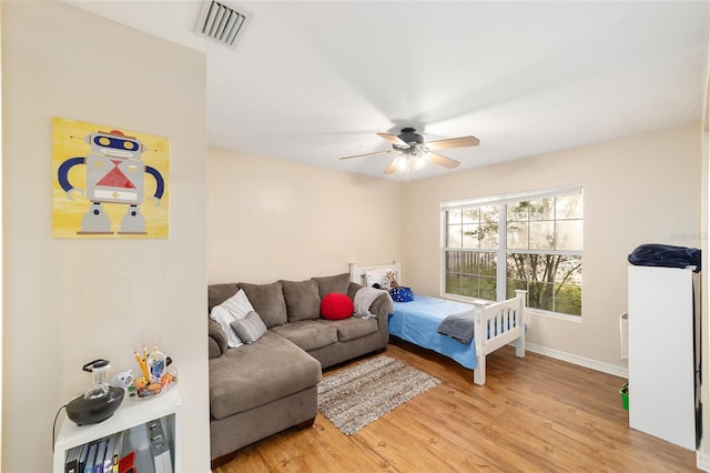 3118 NW 79th Ct, Gainesville, FL 32606 - bedroom with light wood finished floors, baseboards, and a ceiling fan