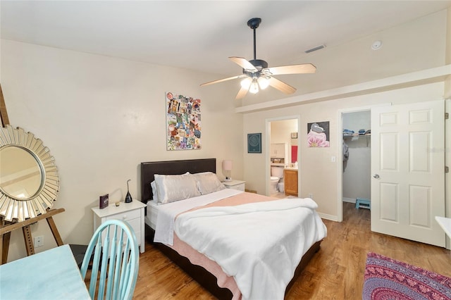 3118 NW 79th Ct, Gainesville, FL 32606 - bedroom with light wood-type flooring, a spacious closet, ensuite bathroom, and a ceiling fan