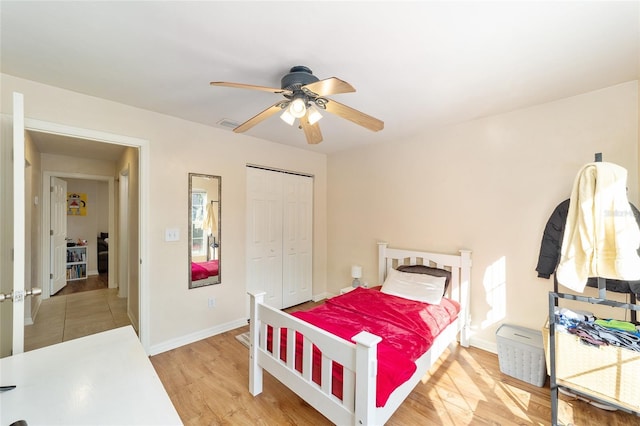 3118 NW 79th Ct, Gainesville, FL 32606 - bedroom with a closet, baseboards, light wood-type flooring, and a ceiling fan