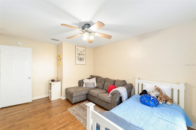 3118 NW 79th Ct, Gainesville, FL 32606 - bedroom with light wood-style flooring, baseboards, and a ceiling fan