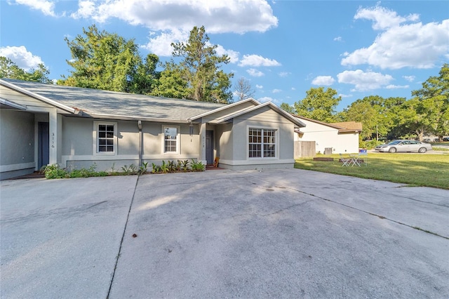 3118 NW 79th Ct, Gainesville, FL 32606 - ranch-style home featuring stucco siding, a front yard, and concrete driveway