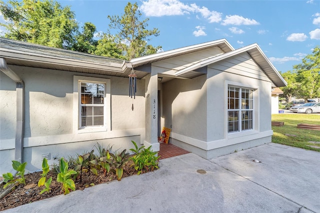 3118 NW 79th Ct, Gainesville, FL 32606 - property entrance featuring stucco siding and a patio