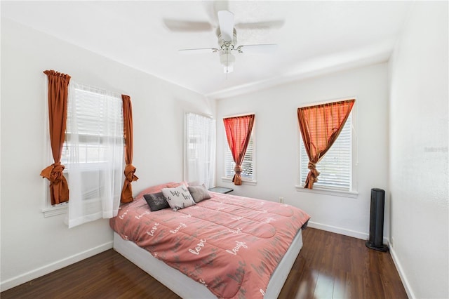bedroom with baseboards, ceiling fan, and wood finished floors